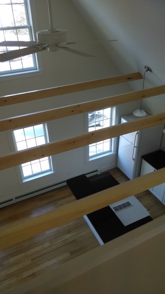 looking down on the living room from the loft at 110 union street rockland maine